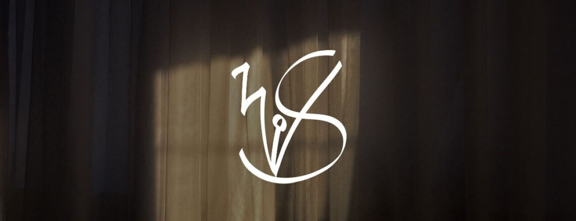 Decorative image of curtains in a home with the sun casting its gentle light on the cloth. The website logo is at the centre with the initials W and S.